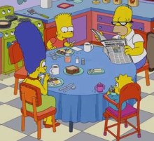 Sentar na mesa ou sentar à mesa?